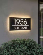 Custom rectangular LED light-up house address sign displaying 1956 Softlane on exterior wall at night