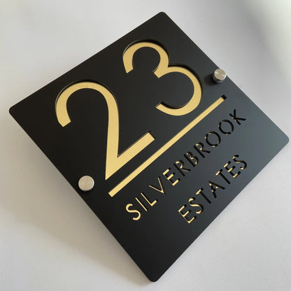 Custom black acrylic house plaque with gold numbers 23 and Silverbrook Estates text on standoffs, square design.