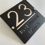 Custom black acrylic square house plaque with number 23 and text Silverbrook Estates on standoffs