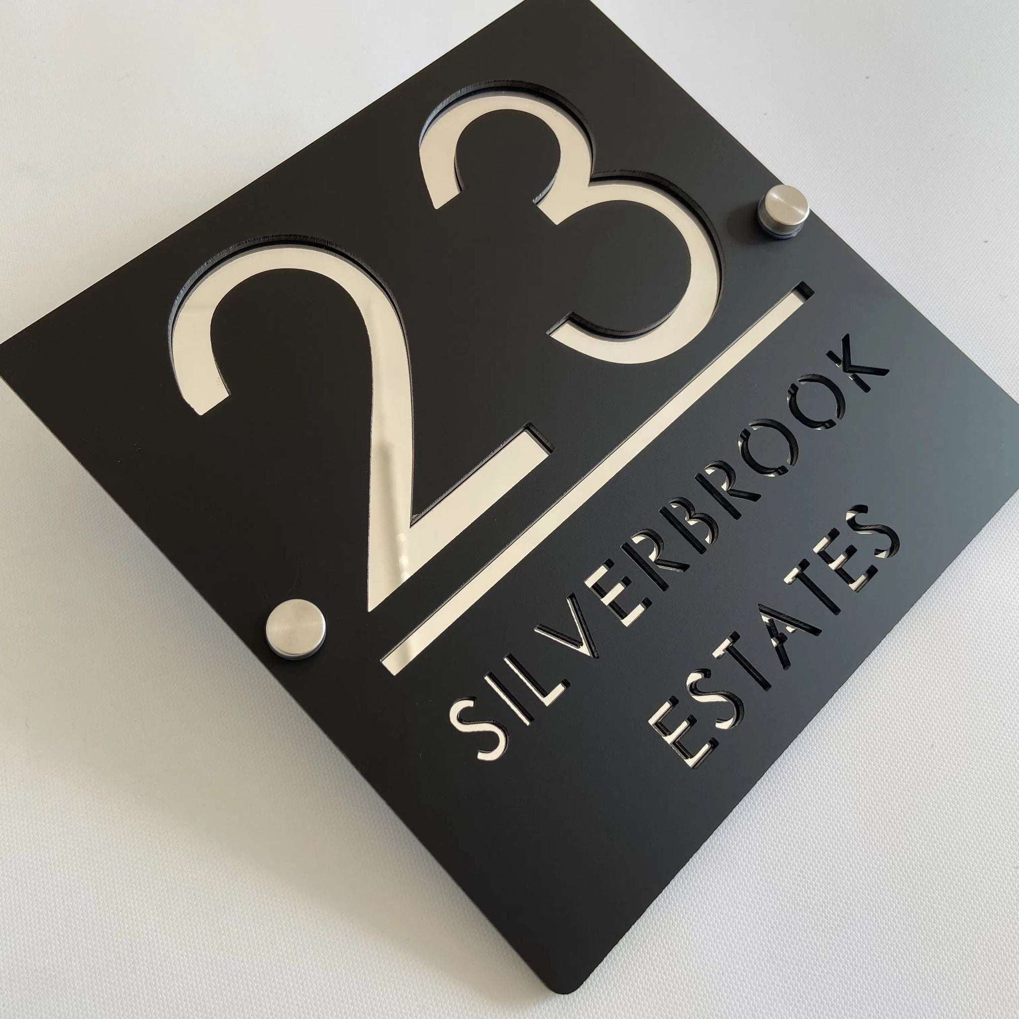 Custom black acrylic square house plaque with number 23 and text Silverbrook Estates on standoffs