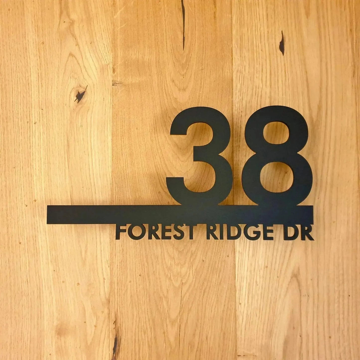 Custom modern floating house number plaque with address Forest Ridge Dr in black on wood background