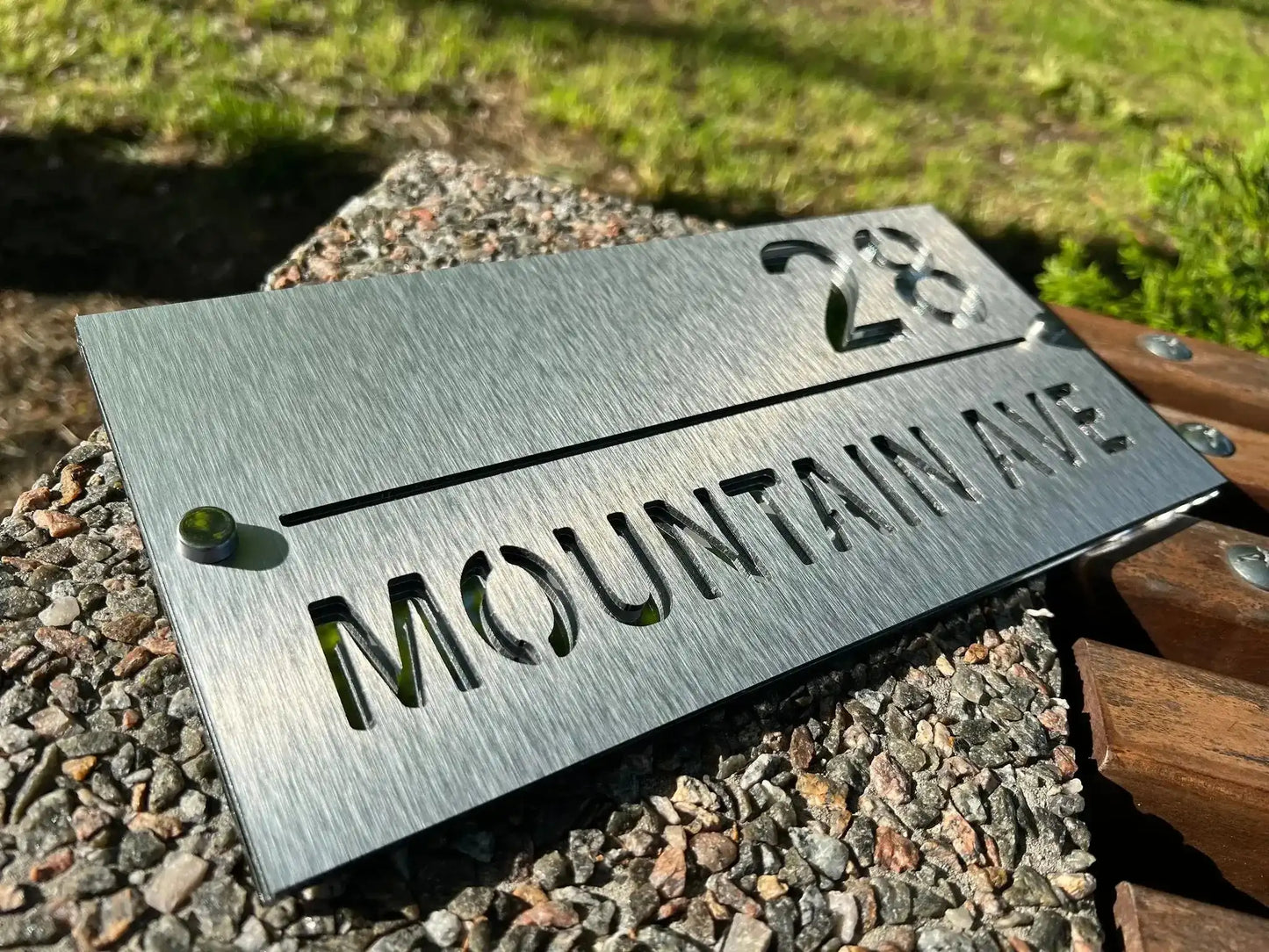 Custom stainless steel address sign with brushed finish showing number 28 and Mountain Ave text.