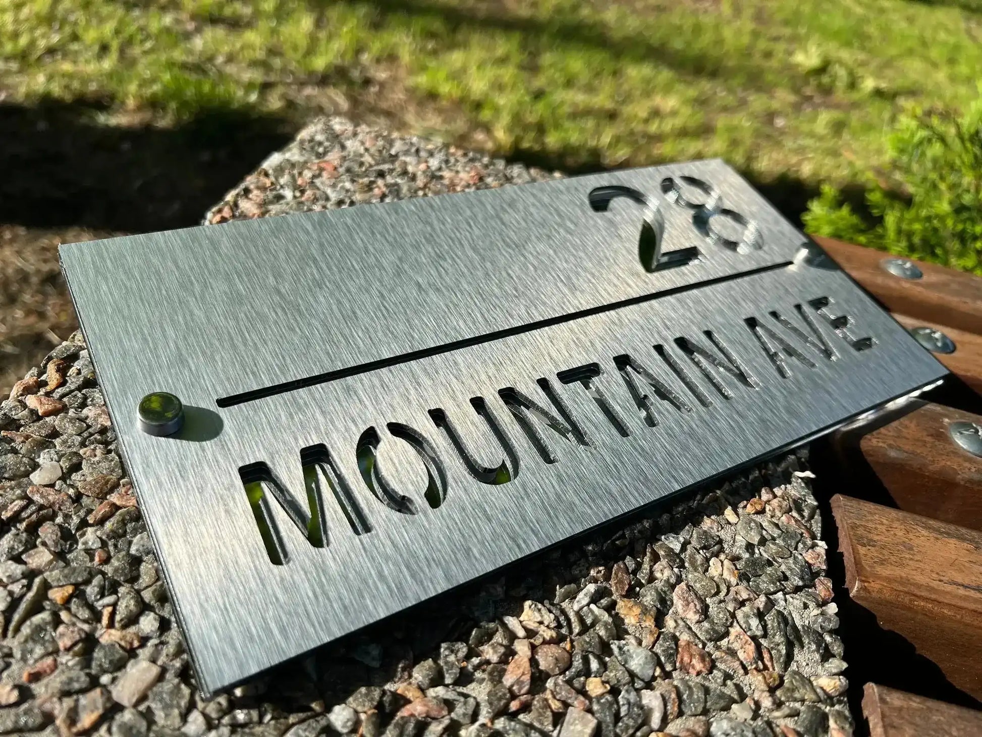 Custom stainless steel address sign with brushed finish showing number 28 and Mountain Ave text.