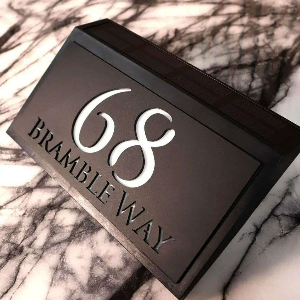 Modern solar-powered custom acrylic house sign with address number and street name on black background