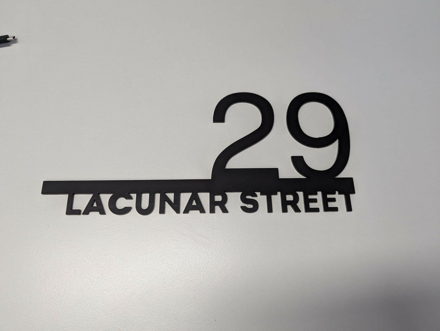 Custom modern floating house number plaque with 29 Lacunar Street in sleek black design on white background